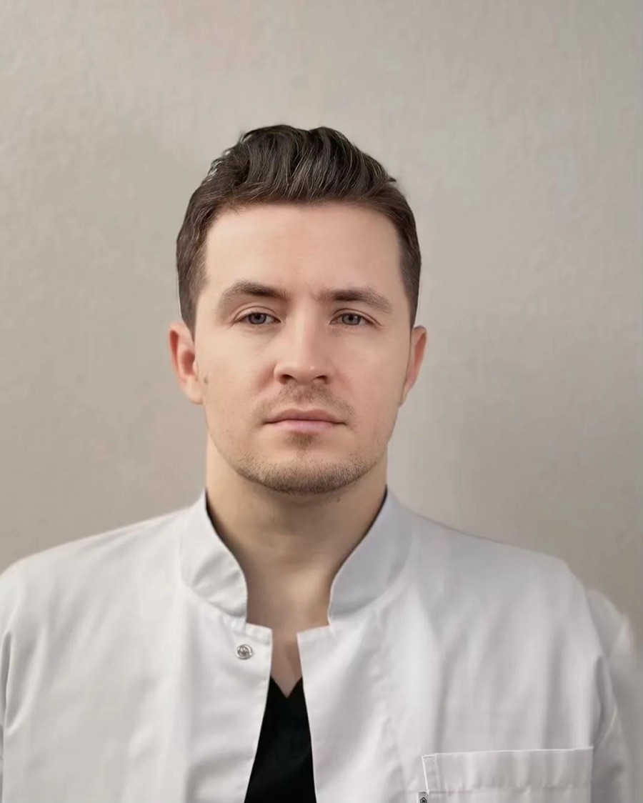 Портрет врача-стоматолога клиники «Парус» в белом медицинском халате